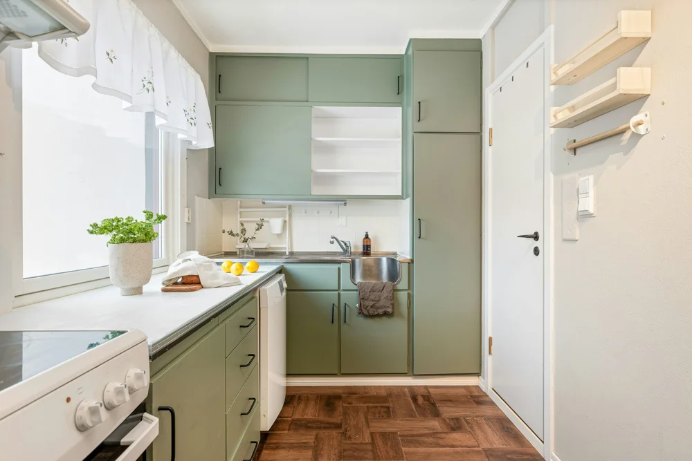 Clean kitchen with cabinets, counters and a sink